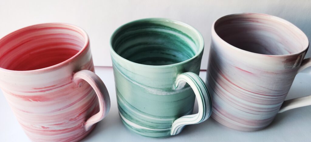 Sandgate Ceramic selection on coloured clay mugs