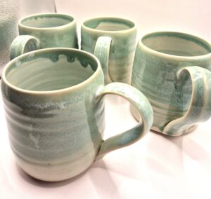 Stoneware green mugs with thin rims